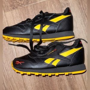 Black and yellow Reebok Classics